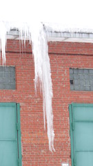 Icicles on a brick wall background.