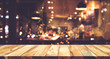 Wood table top (Bar) with blur night cafe background
