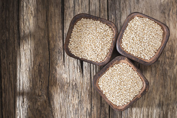 Wall Mural - quinoa beans in bowl on rustic wooden background