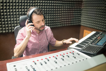 Sound engineer working in soundproof recording studio