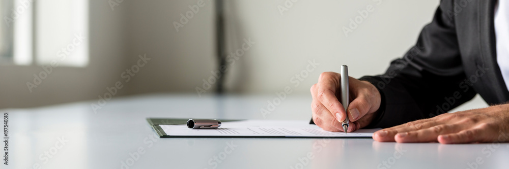Wide panorama view of businessman hand signing legal or insurance document - obrazy, fototapety, plakaty 