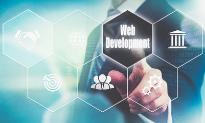 Businessman pressing a Web Development business concept button.