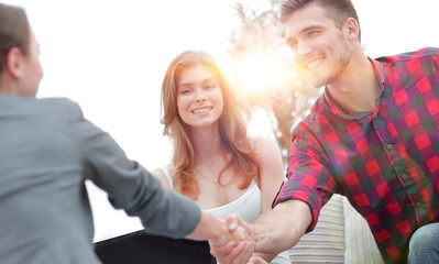 woman psychologist greets the customer before the beginning of the family session.