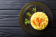 Delicious Italian risotto with saffron and mint (Risotto alla milanese) closeup. horizontal top view from above