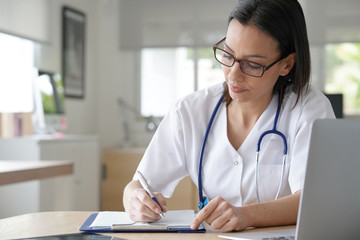 Portrait of nurse writing prescription