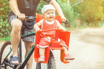 dad with his daughter on a bike