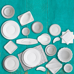 Wall Mural - Set of different white porcelain dishes on Aquamarine background. Copy space. 