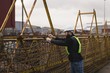 © Wavebreak Media - Dock worker adjusting net