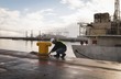 © Wavebreak Media - Dock worker tying rope on bollard