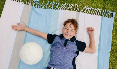 Boy with football enjoying in a park