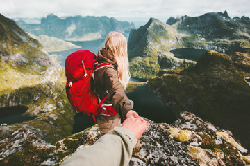 couple travelers follow holding hands in mountains norway landscape love and travel lifestyle concep