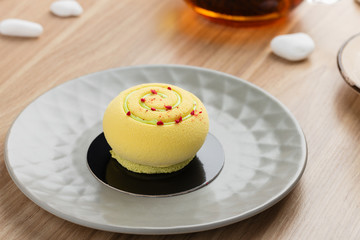 Sticker - Mini mousse cake covered with yellow chocolate velour on gray plate