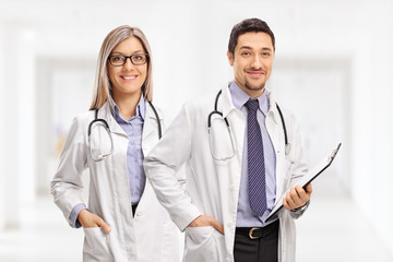 Wall Mural - Female doctor and a male doctor with a clipboard