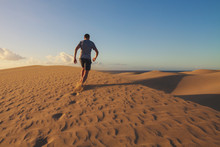 Man Is Running On Sand Dunes In Maspalomas.