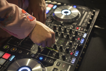  Dj hand on mixes music station during party 