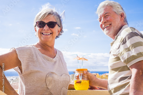 Fotografie, Obraz SENIOR COUPLE DRINKING in terrace rooftop