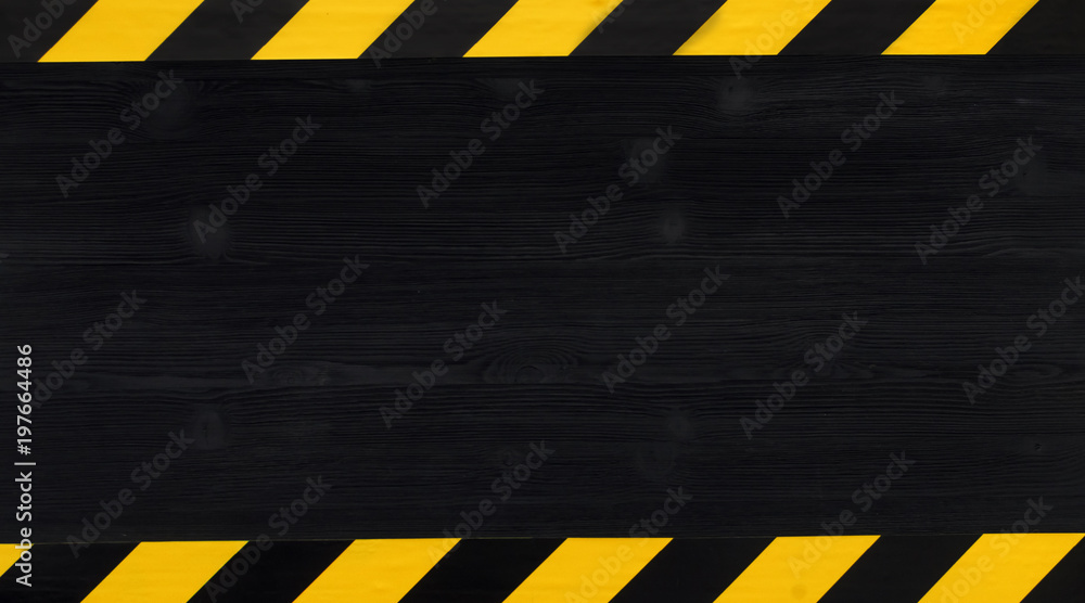 Under construction concept background. Warning tape frame on black wooden surface background with copy space. - obrazy, fototapety, plakaty 