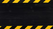 Under construction concept background. Warning tape frame on black wooden surface background with copy space.