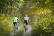 © sergo321 - a woman and a man cycling in summer in the park on bicycles