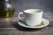 © Cavan Images - Close up of chamomile tea with flowers on table