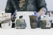 © Cavan Images - Midsection of craftsman working in workshop with craft products on workbench