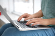© New Africa - Young woman using laptop indoors, closeup