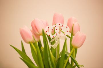 Wall Mural - Beautiful pink tulip in the vase with two wood heart, spring time