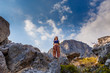 © mishamif - woman stands on a mountain and looks over