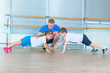 © satyrenko - Group of children doing kids gymnastics in gym with teacher. Happy sporty children in gym. bar exercise. plank.