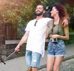 Poster - Cheerful young couple walking on urban street