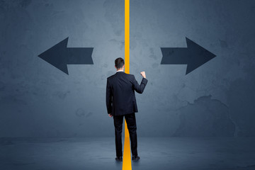 Wall Mural - Business person choosing between two options separated by a yellow border arrow