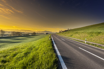 Wall Mural - Asphalt road along the pasture