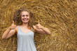 © AnastazjaSoroka - A smiling young woman with a blond with disheveled hair on the background of hay. Copy space. Nasty hair concept.