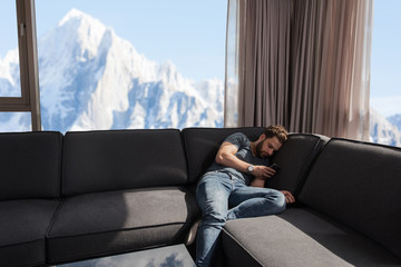 young casual man using a mobile phone at home