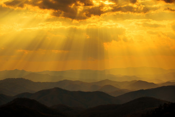 sunset sky with sun rays over the mountains
