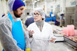 © pressmaster - Fish factory expert with touchpad explaining one of workers how to improve working conditions