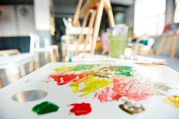 Fototapete - Palette of an artist with some vibrant colors for mixing in studio of painting