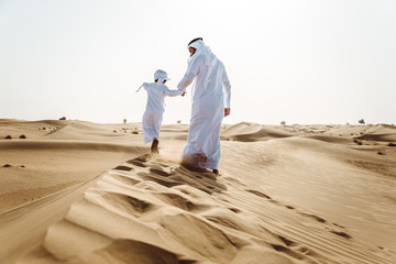 Wall Mural - father and son spending time in the desert