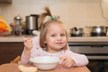 1,5 years baby girl eating by herself