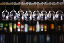 Group Of Wine Glasses Hanging Above A Bar Rack In Pub & Restaurant