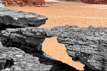Erosion Formed Stone Bridge, Black And White Alienated With Colored Background And Abstract Effect, In The Nature Reserve Of Wadi Rum, Jordan