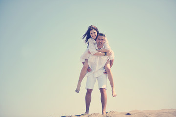 Wall Mural - happy young couple have fun on beach