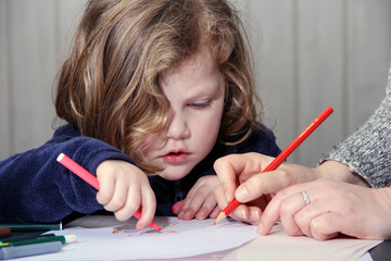 mother and daughter drawing together at home.