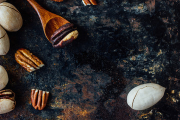 Canvas Print - Pecan nut and wooden spoon on rustic table.