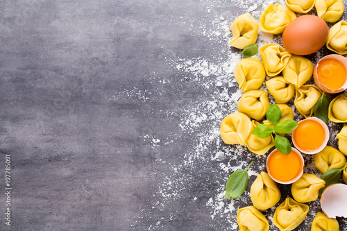 Zdjęcie XXL Domowej roboty surowi Włoscy tortellini i basilu liście.