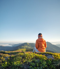 Tourist relax on the mountain top. Sport and active life concept