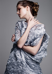 Beautiful fashion model wearing blue silk dress
