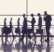 © Yakobchuk Olena - Employees passing through workplace in business center. Panoramic window on background