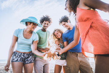 Wall Mural - Friends partying on the beach