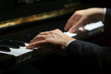 Professional Musician Pianist Hands On Piano Keys Of A Classic Piano In The Dark.
